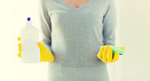 Oven cleaning specialist wearing PPE during appliance cleaning